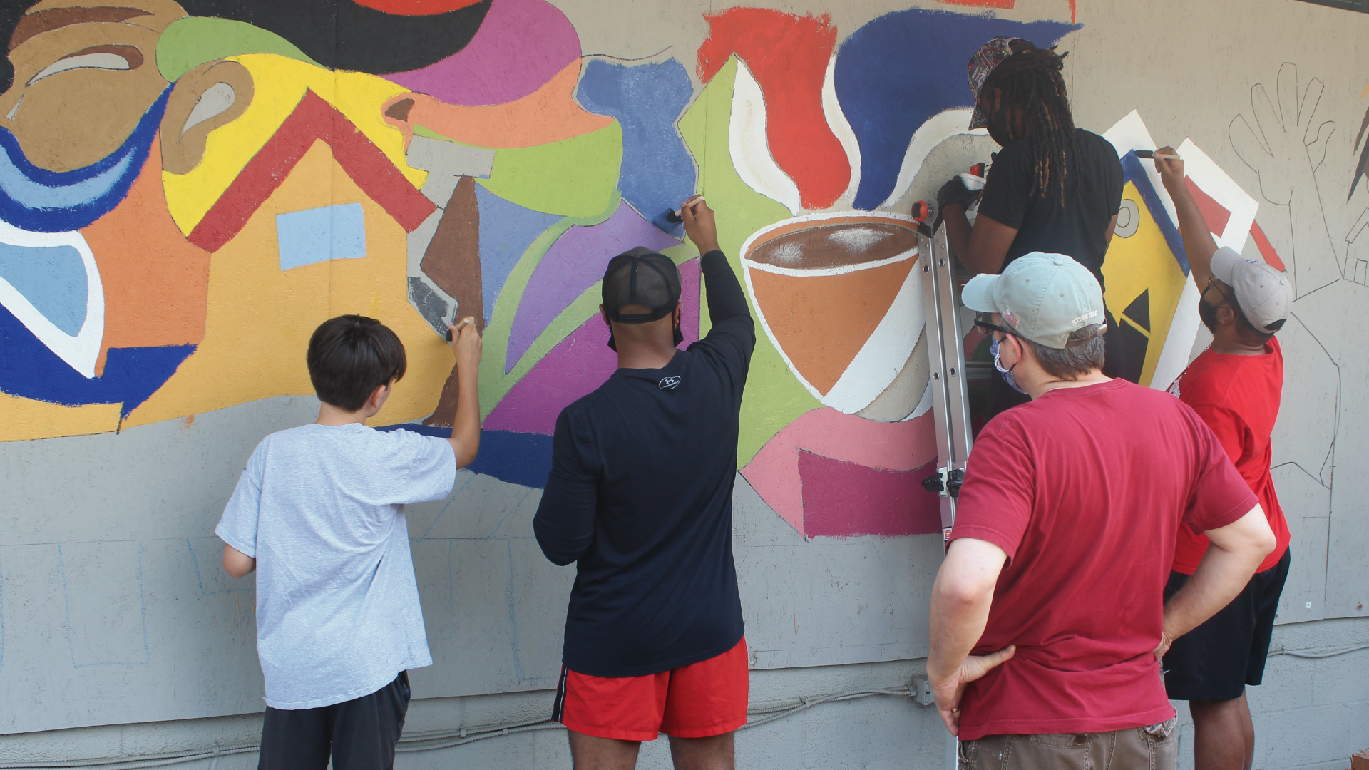 students paint mural